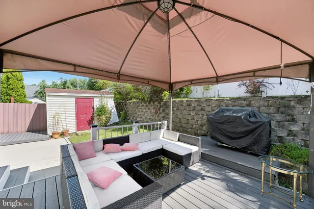 a view of table and chairs under an umbrella