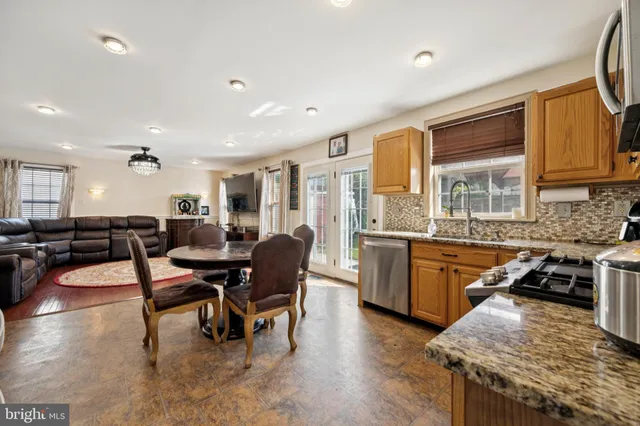 a large kitchen with lots of counter top space and stainless steel appliances