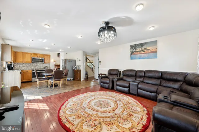 a living room with furniture kitchen view and a table
