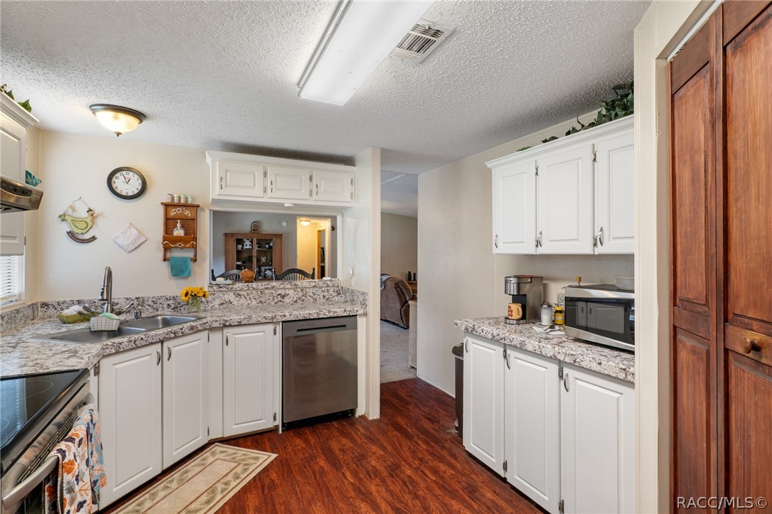 7927 West Cyprian Court Homosassa, FL 34448 - Photo 14 of 40 a kitchen with a sink stove and cabinets