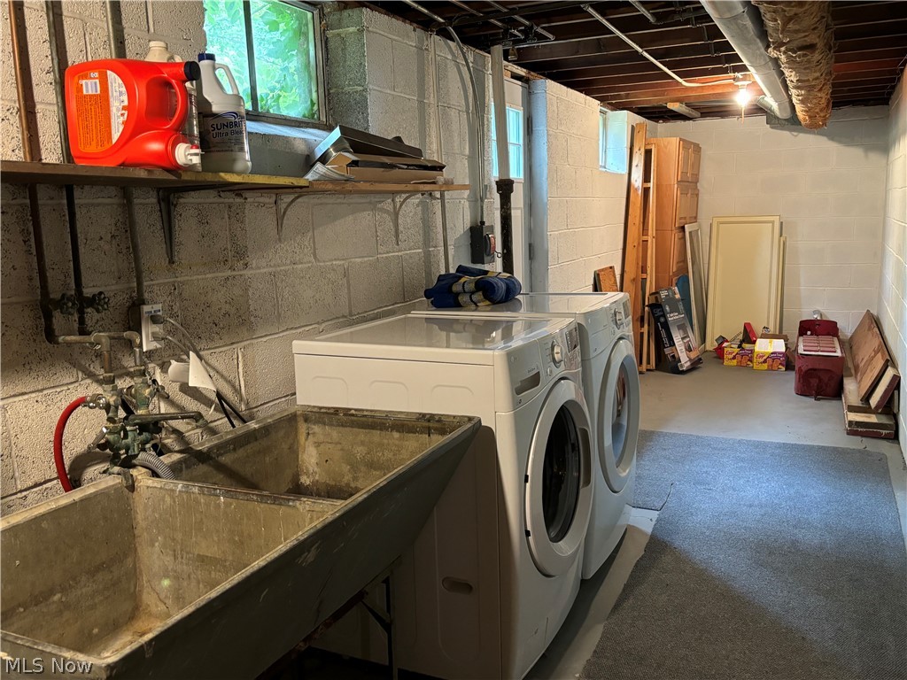7595 Webster Road Cleveland, OH 44130 - Photo 41 of 45 Large laundry area in the basement with plenty of natural light and a door to the back yard