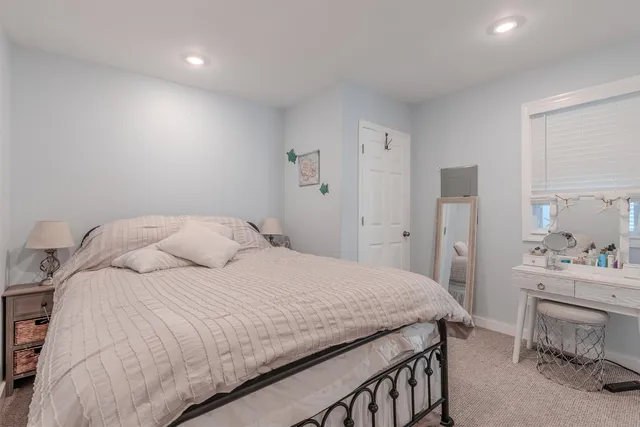 a bedroom with a bed and a car in it