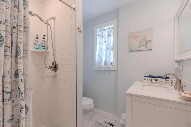 a bathroom with a toilet sink and shower