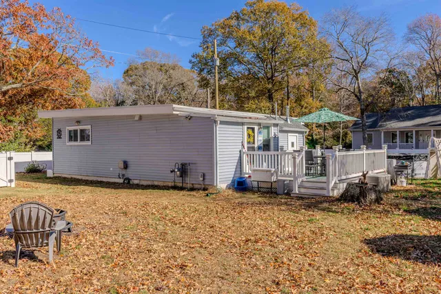 a backyard of a house with barbeque oven