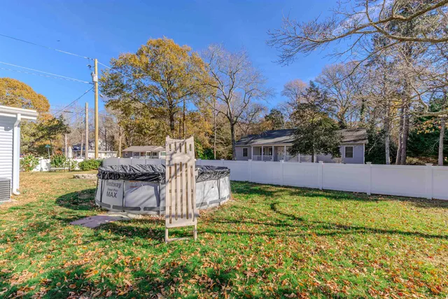 a view of a garden with large trees