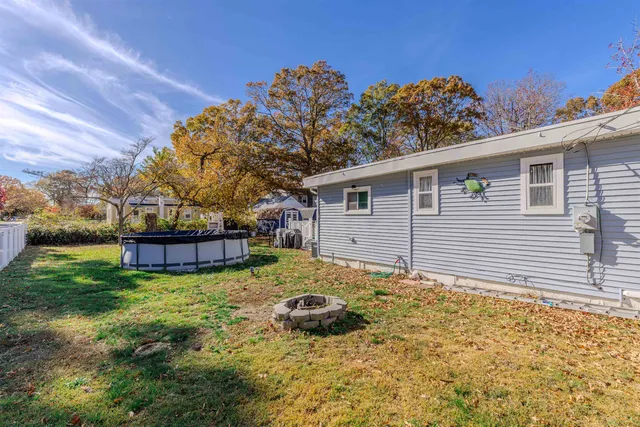 a view of a house with a yard and sitting area