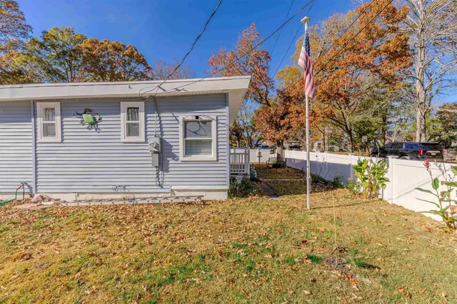 a backyard of a house with table and chairs
