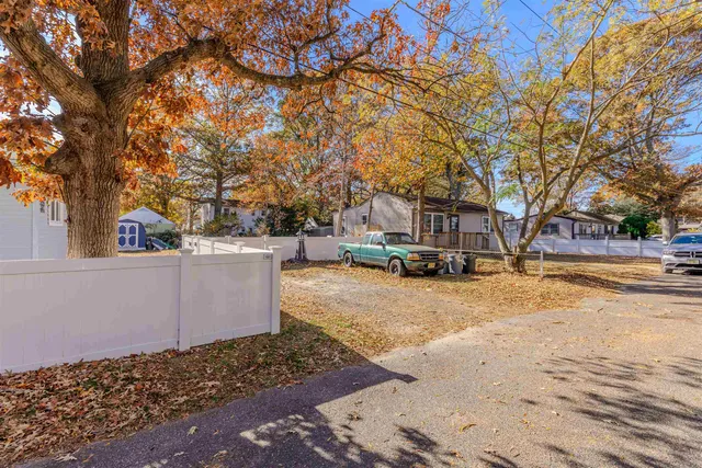 a view of a yard with snow on the road