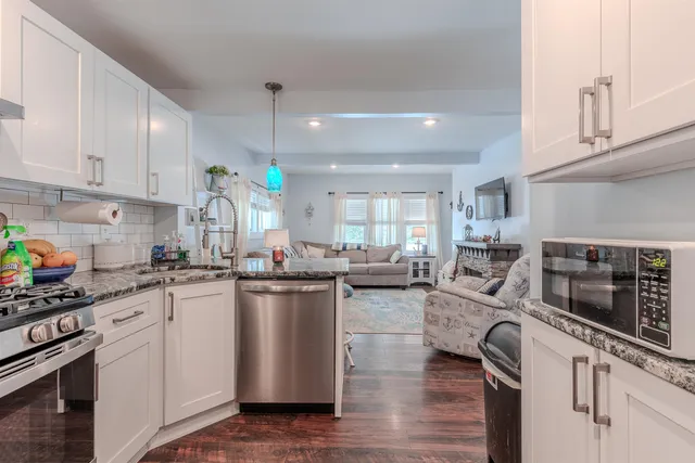 a kitchen with cabinets a sink and appliances