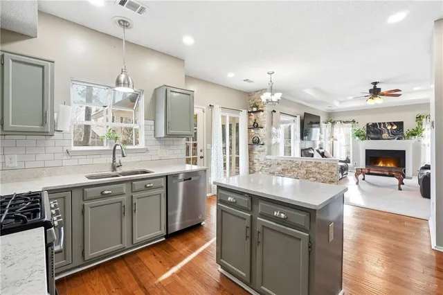a kitchen with a sink stove and cabinets