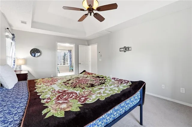 a bedroom with a bed and ceiling fan