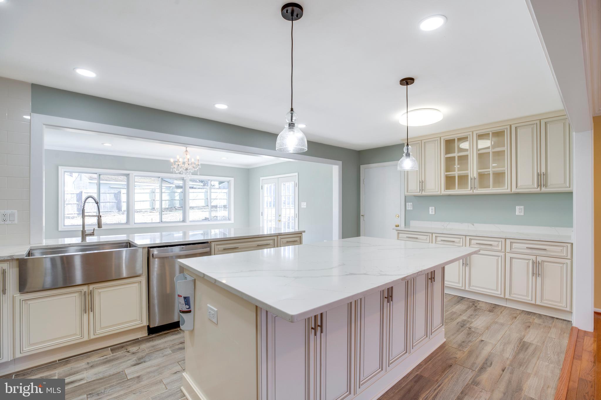 11905 Basswood Drive Laurel, MD 20708 - Photo 11 of 51 a kitchen with stainless steel appliances granite countertop a sink a oven a counter space and wooden floor