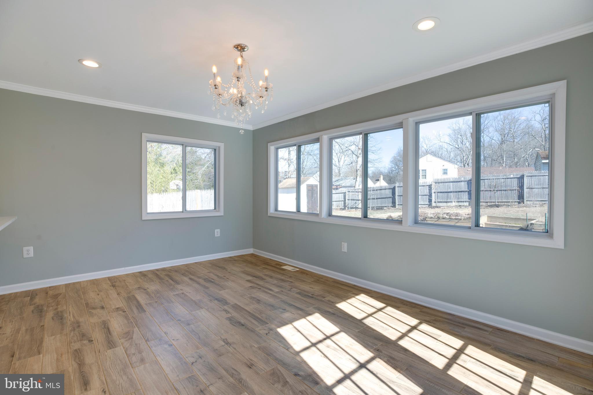 11905 Basswood Drive Laurel, MD 20708 - Photo 16 of 51 a view of an empty room with wooden floor and a window