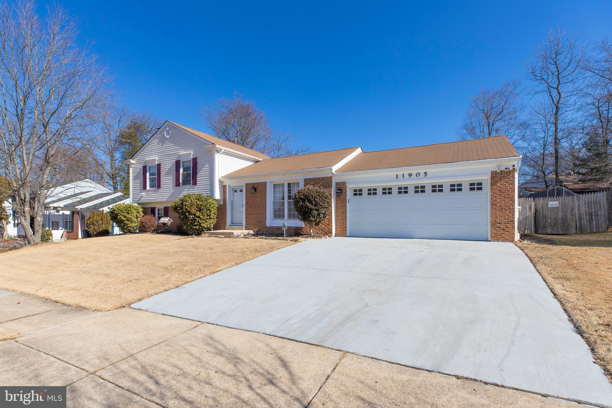 11905 Basswood Drive Laurel, MD 20708 - Photo 2 of 51 a front view of a building with a yard
