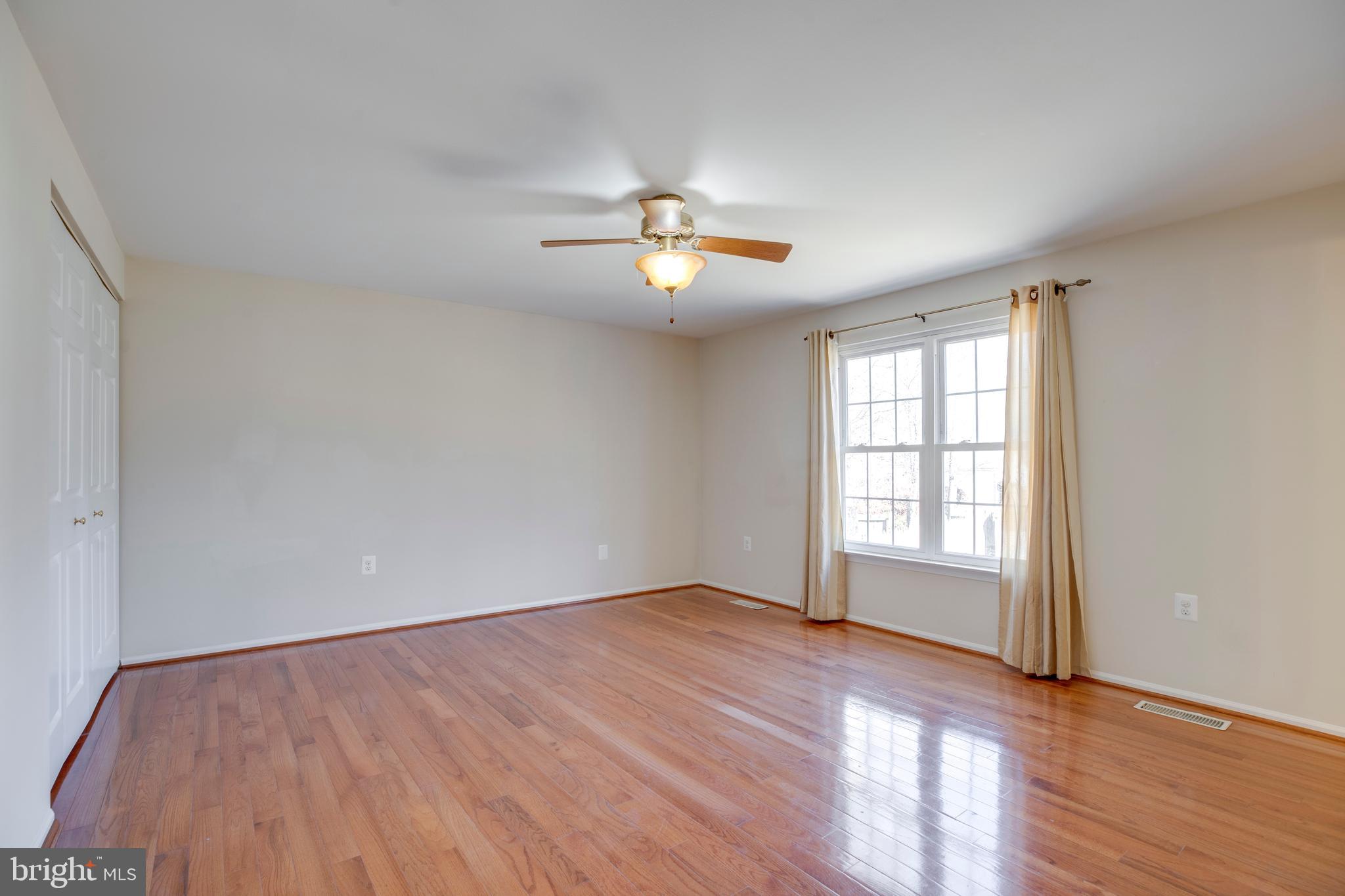 11905 Basswood Drive Laurel, MD 20708 - Photo 21 of 51 wooden floor in an empty room with a window