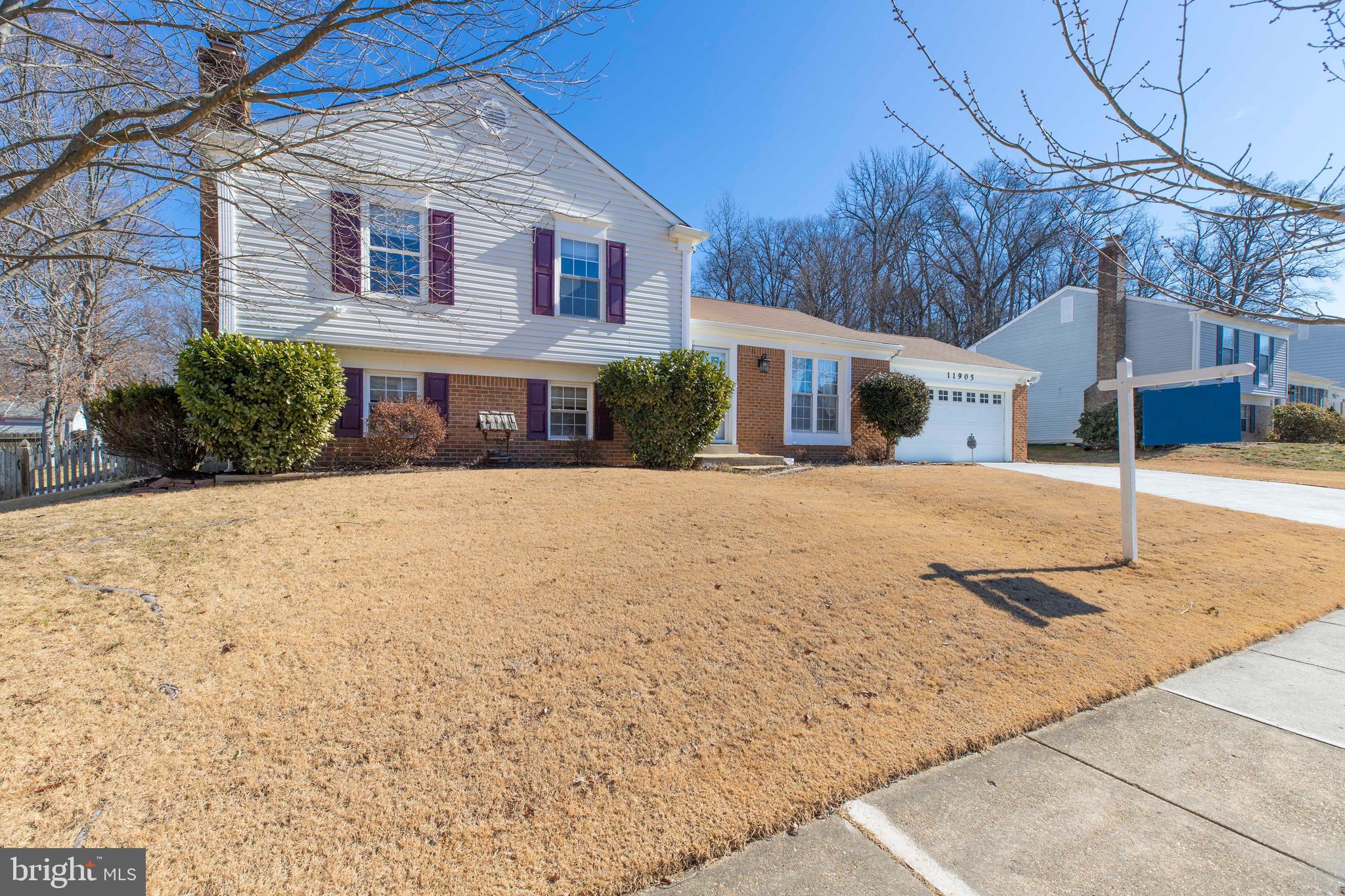 11905 Basswood Drive Laurel, MD 20708 - Photo 3 of 51 a view of a white house with a large tree