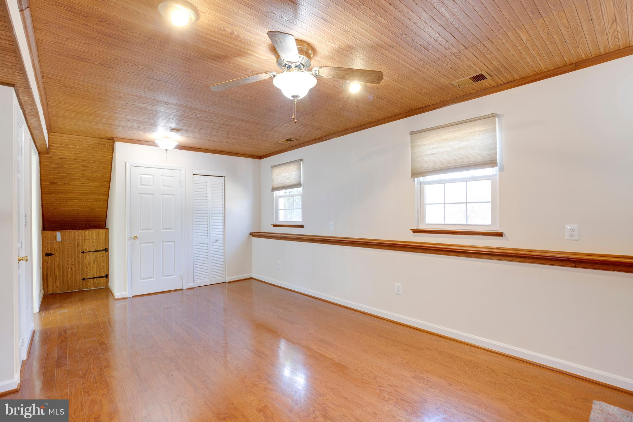 11905 Basswood Drive Laurel, MD 20708 - Photo 33 of 51 an empty room with wooden floor and windows