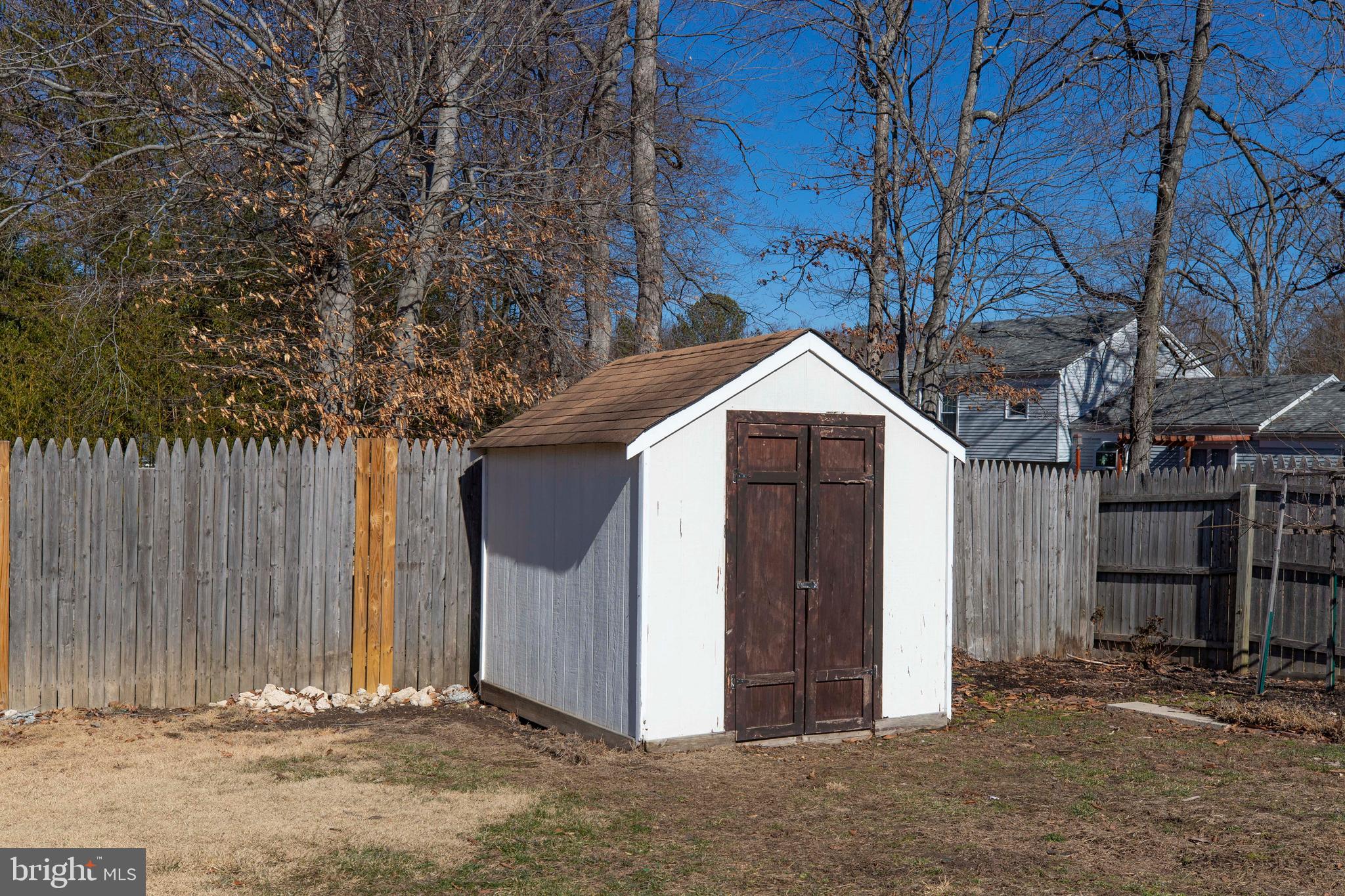 11905 Basswood Drive Laurel, MD 20708 - Photo 48 of 51 a view of a wooden house with a large tree and wooden fence