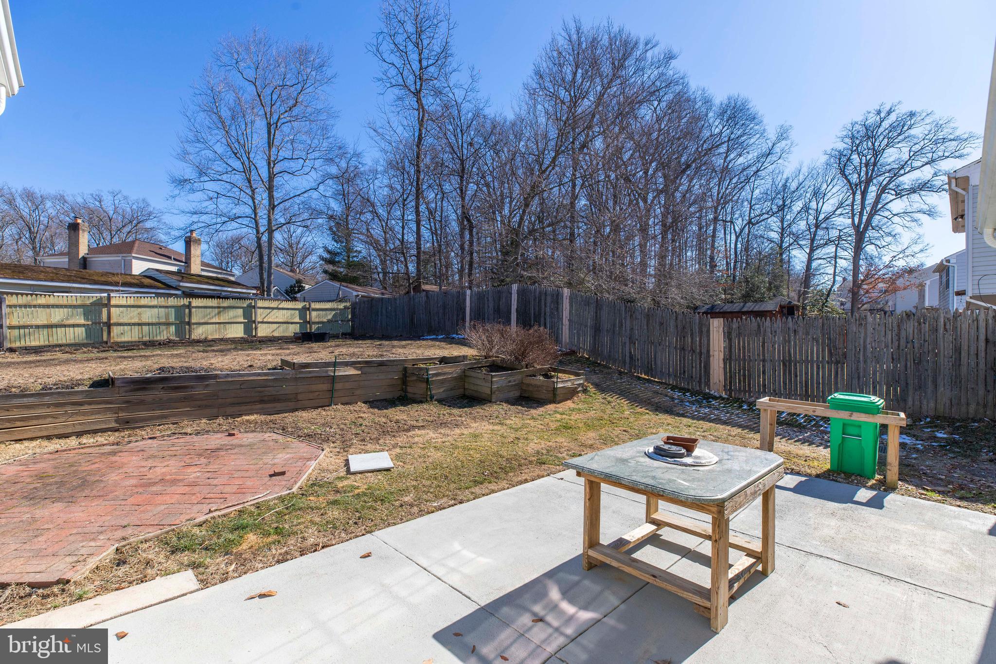 11905 Basswood Drive Laurel, MD 20708 - Photo 51 of 51 a view of a backyard with table and chairs potted plants and wooden fence