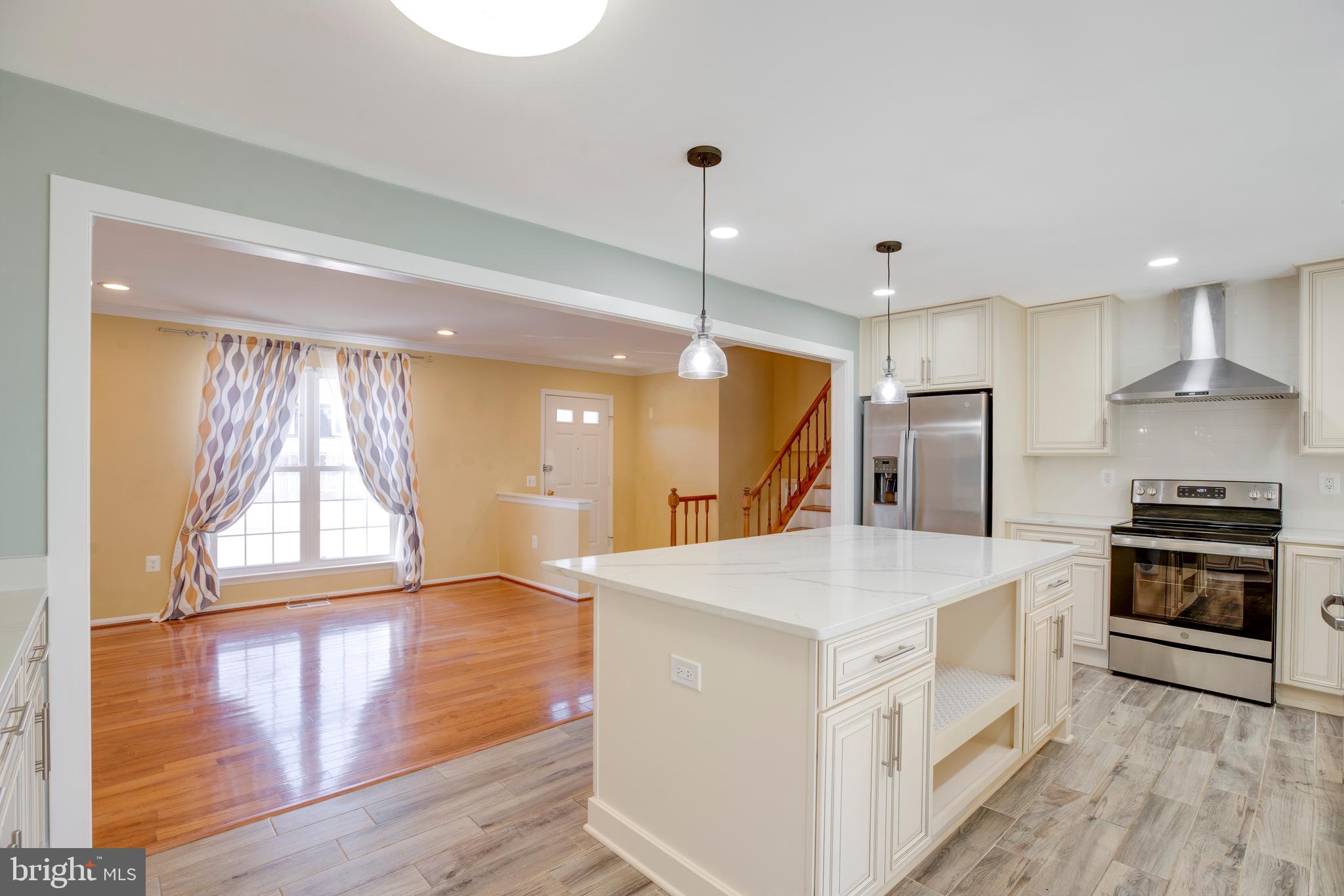 11905 Basswood Drive Laurel, MD 20708 - Photo 7 of 51 a kitchen with a stove a sink and a refrigerator