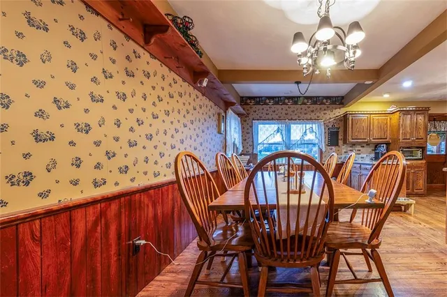 a view of a dining room with furniture chandelier and wooden floor