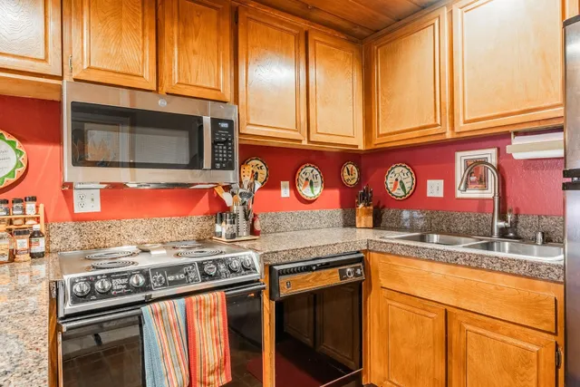 a street with stainless steel appliances granite countertop a stove and cabinets