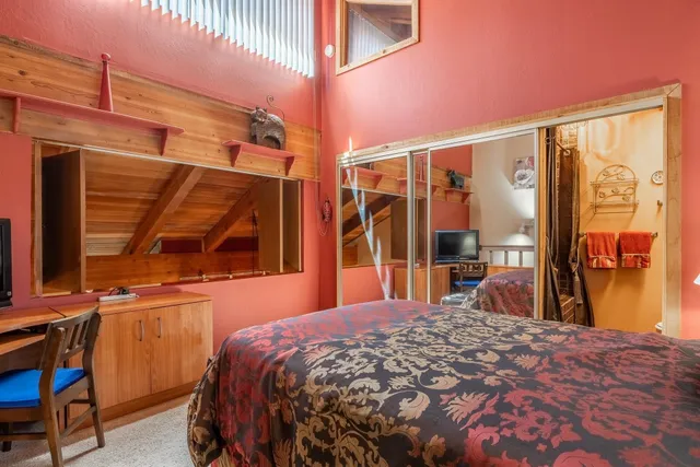 a bed sitting in a bedroom next to a window