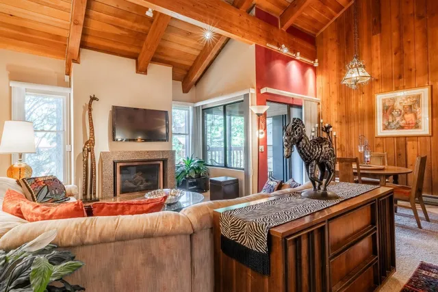 a living room with a fireplace furniture and a flat screen tv