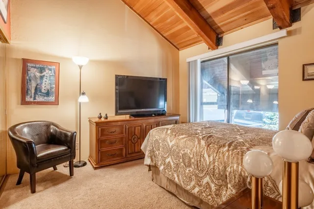 a bed sitting in a bedroom next to a window