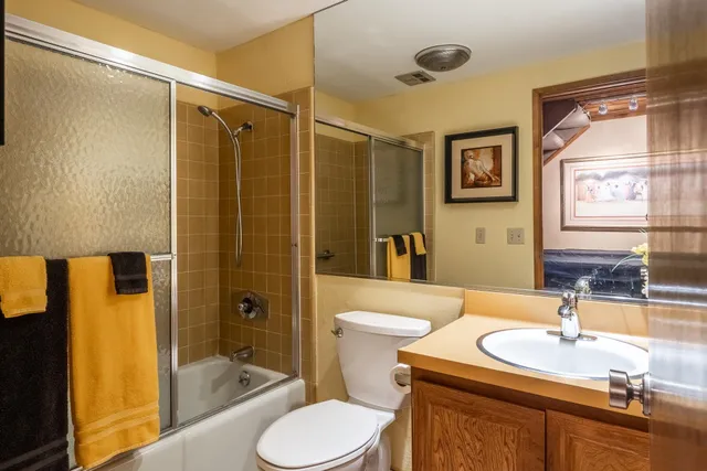 a view of a hallway and a dining room with furniture window and wooden floor