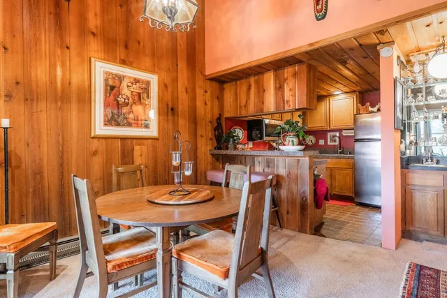 a view of a dining room with furniture and a chandelier
