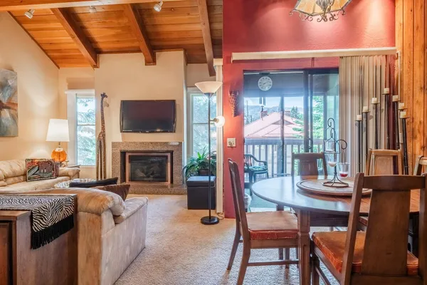 a living room with fireplace furniture and a large window