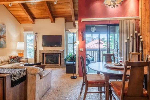 a living room with fireplace furniture and a large window