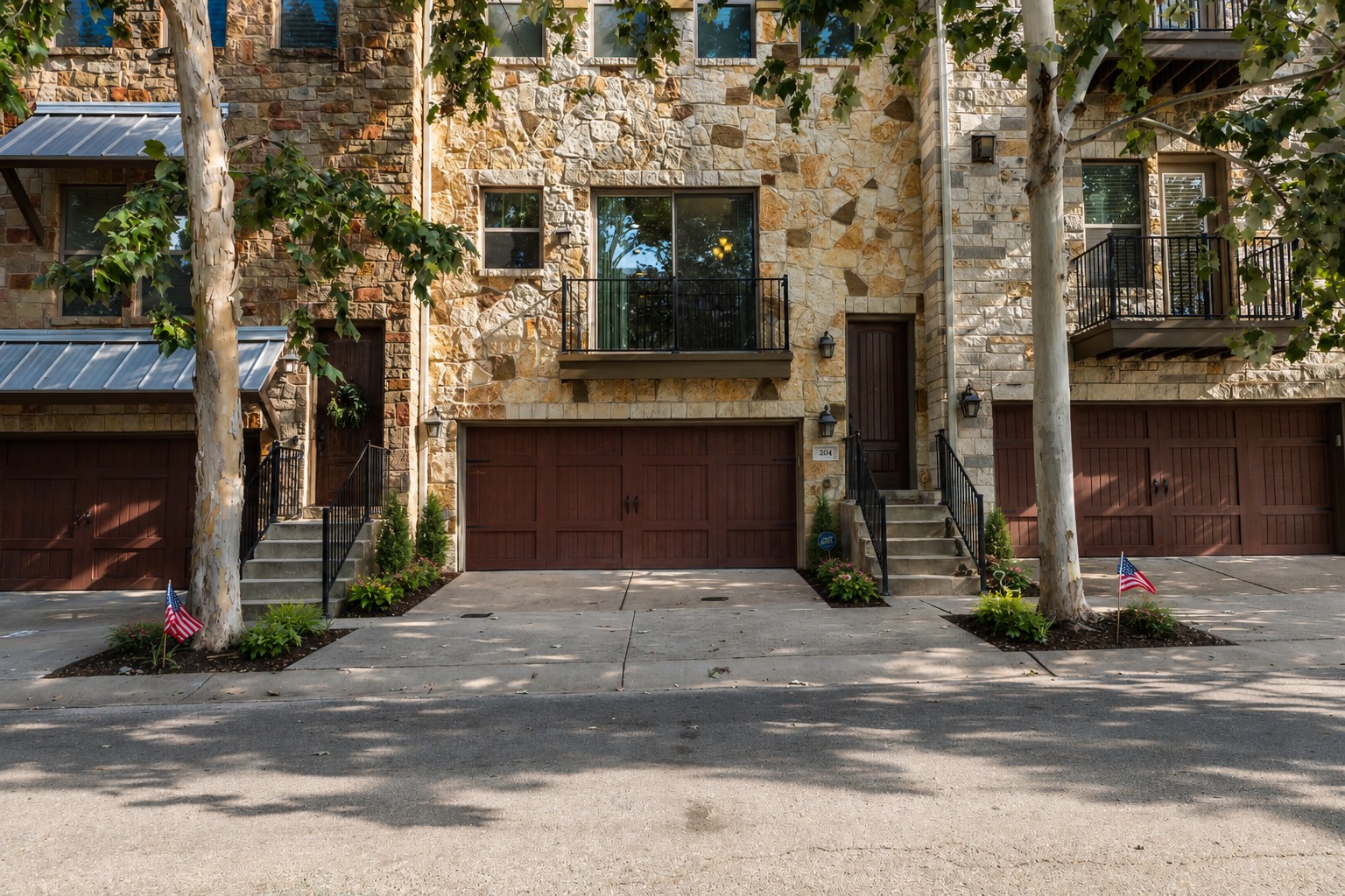 204 Adams Street Georgetown, TX 78628 - Photo 1 of 33 Natural stone facade adorns this charming townhouse, offering an inviting entry with a private garage.