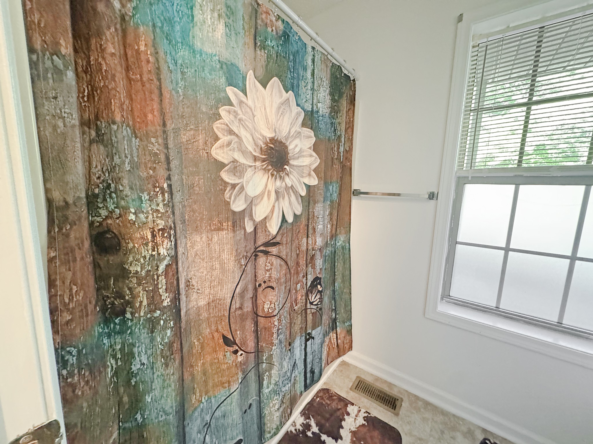 127 Lena Sykes Road Dover, TN 37058 - Photo 11 of 26 a bathroom with a shower curtain and window