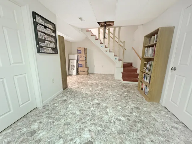 a view of entryway with stairs and wooden floor