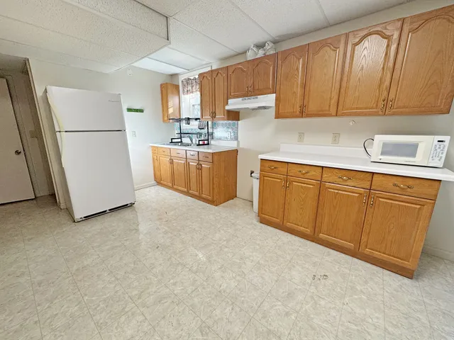a kitchen with refrigerator and cabinets
