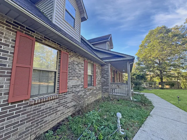 a view of house with backyard