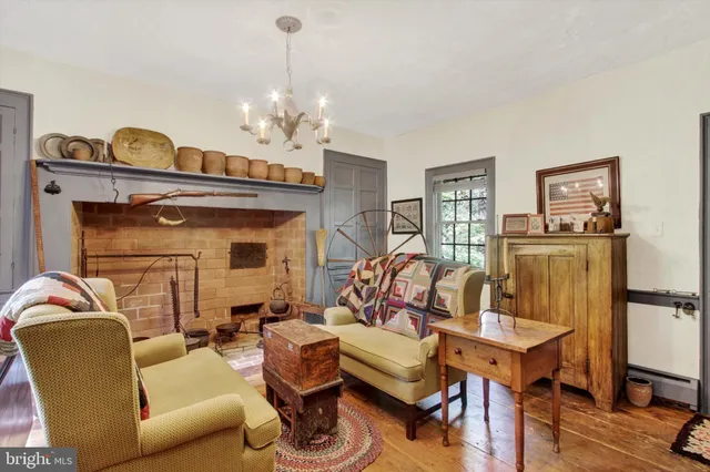 a kitchen with stainless steel appliances granite countertop a table chairs and a refrigerator