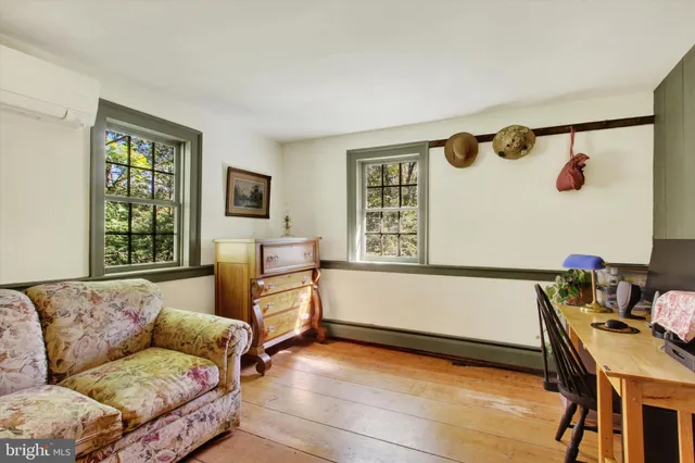 a view of backyard with a barn and large trees