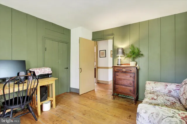 a backyard of a house with large trees and plants