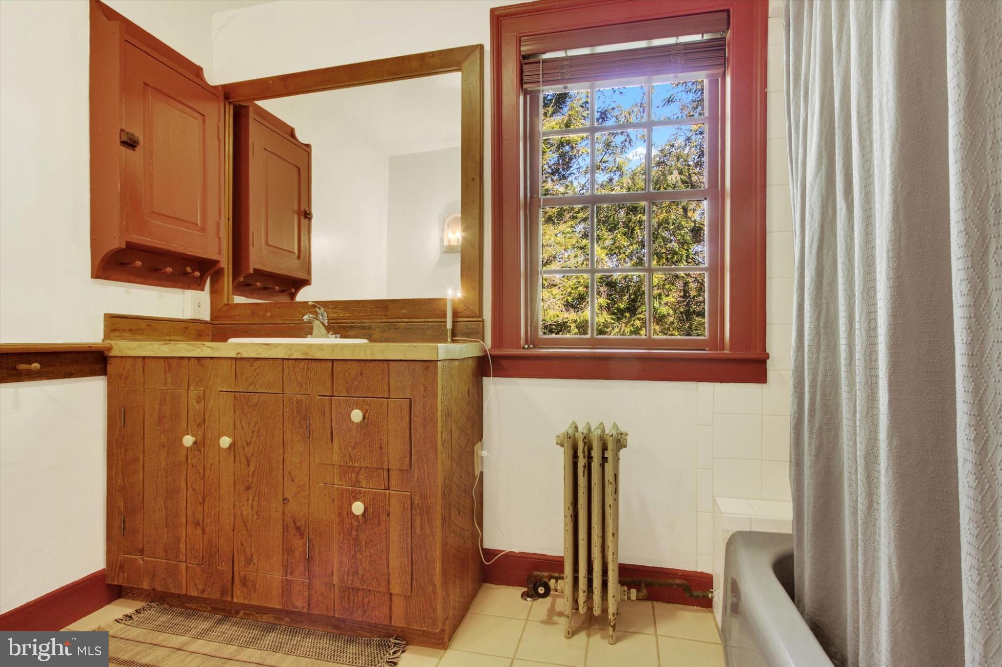 39 Kuhn Fording Road East Berlin, PA 17316 - Photo 52 of 71 a bathroom with a sink a mirror and a window