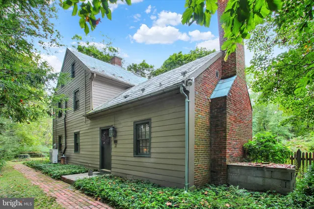 a front view of a house with lots of green space