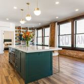 a kitchen with stainless steel appliances granite countertop counter space and wooden floors