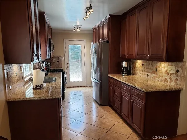 a kitchen with a sink and a refrigerator