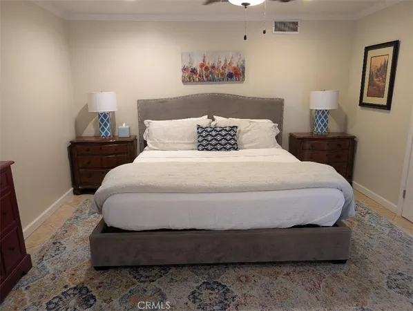 a large bed sitting in a bedroom next to a lamp