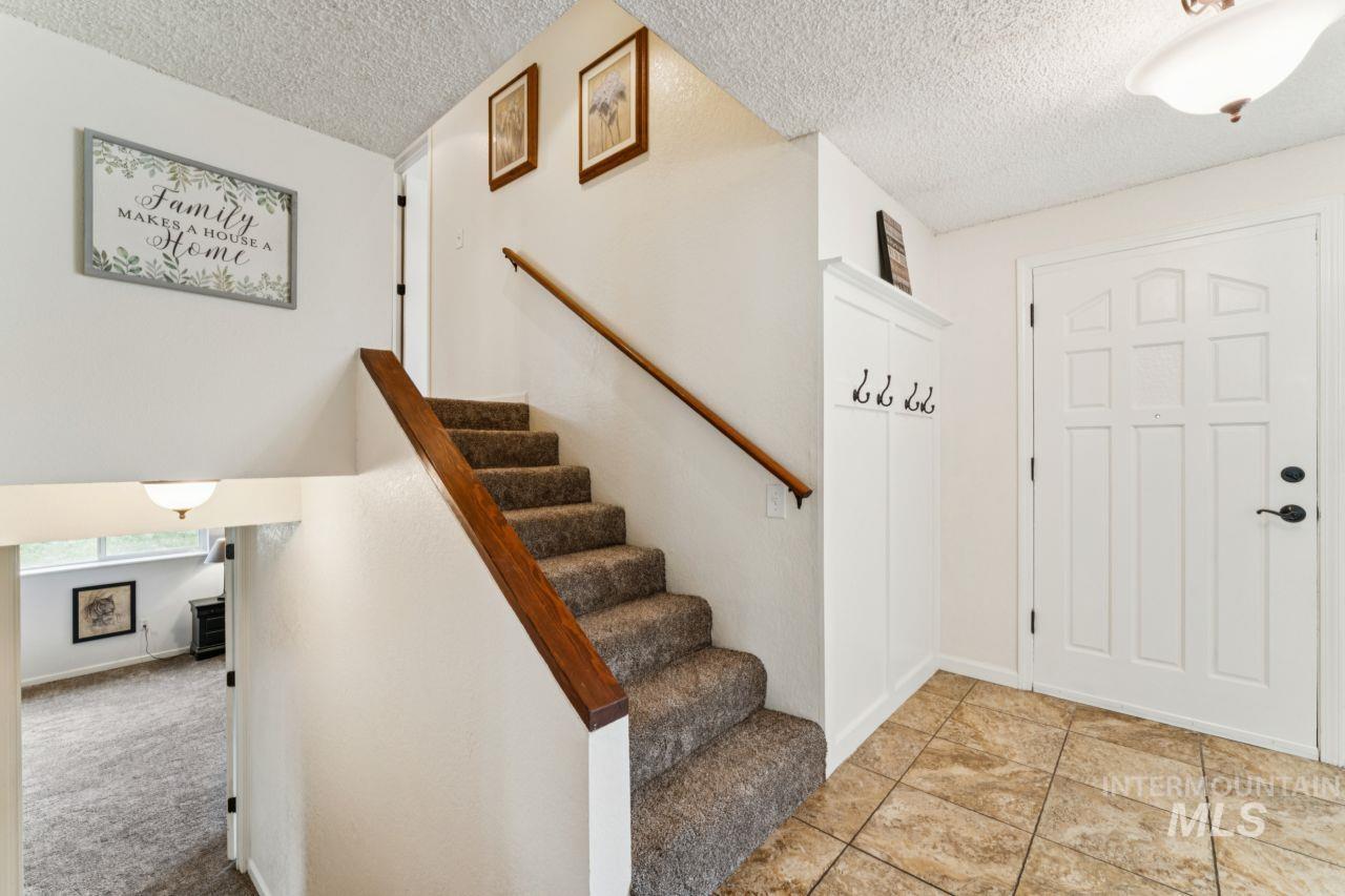 4093 North Marylebone Way Boise, ID 83713 - Photo 18 of 48 Entrance foyer with stairway and a textured ceiling