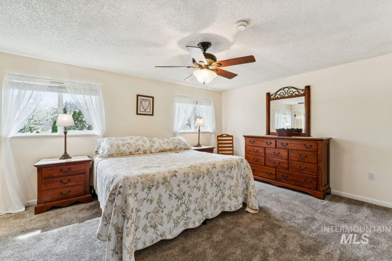 4093 North Marylebone Way Boise, ID 83713 - Photo 19 of 48 Bedroom featuring carpet flooring, a textured ceiling, and ceiling fan