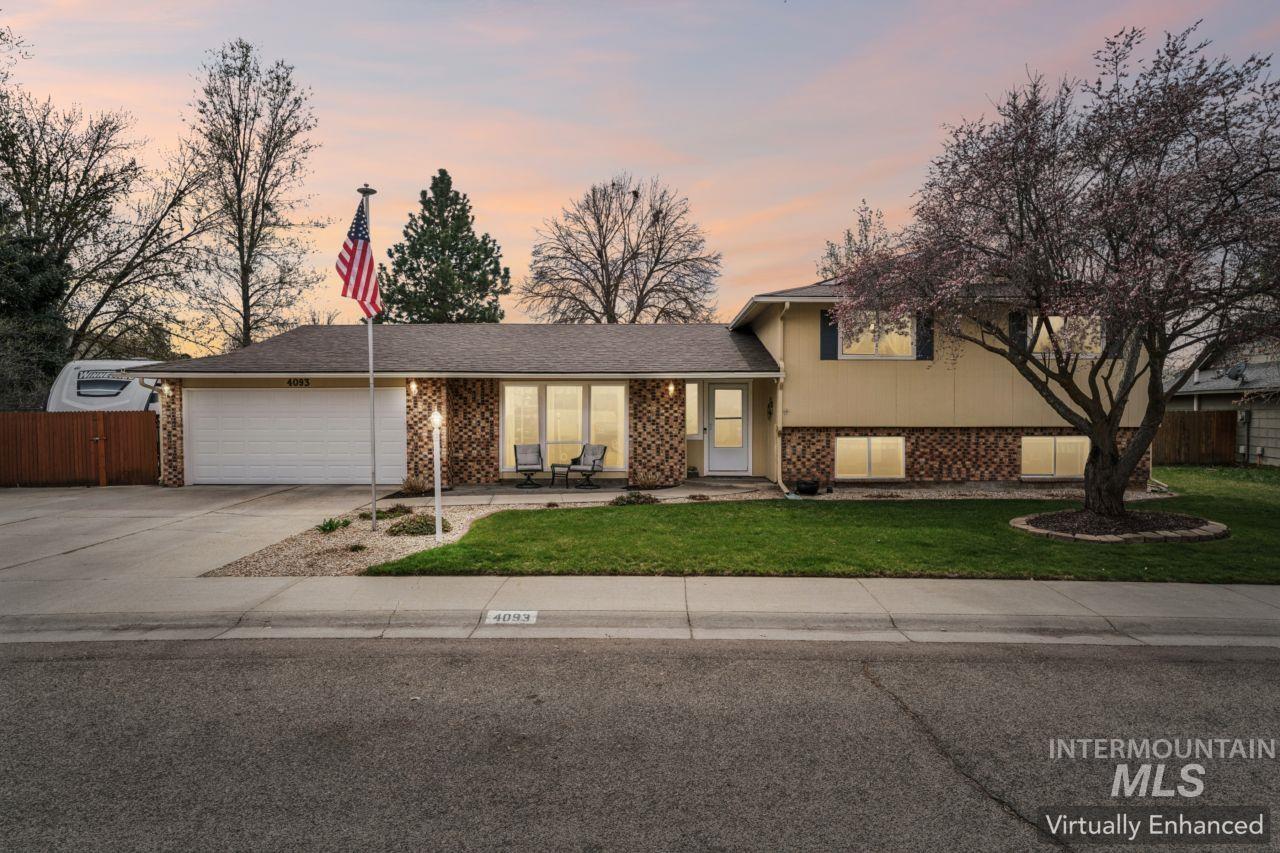 4093 North Marylebone Way Boise, ID 83713 - Photo 2 of 48 Tri-level home featuring brick siding, an attached garage, driveway, and a porch