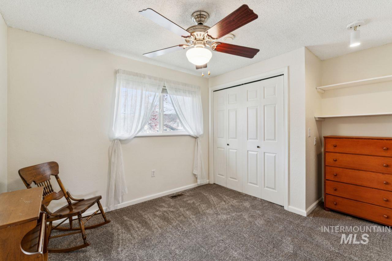 4093 North Marylebone Way Boise, ID 83713 - Photo 25 of 48 Bedroom featuring a textured ceiling, ceiling fan, dark carpet, and a closet